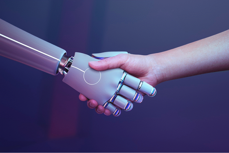 Human hand shaking a silver robotic prosthetic hand, symbolizing collaboration between people and technology.